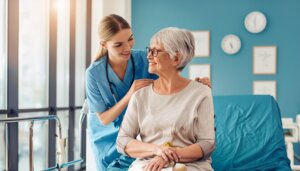 a nurse caring for an older patient at the hospital
