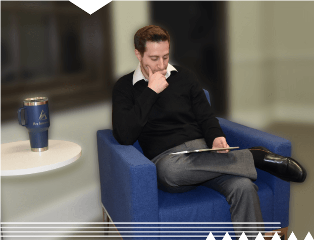 Matt sitting in a chair working on a tablet