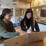 May and Olivia working on laptops