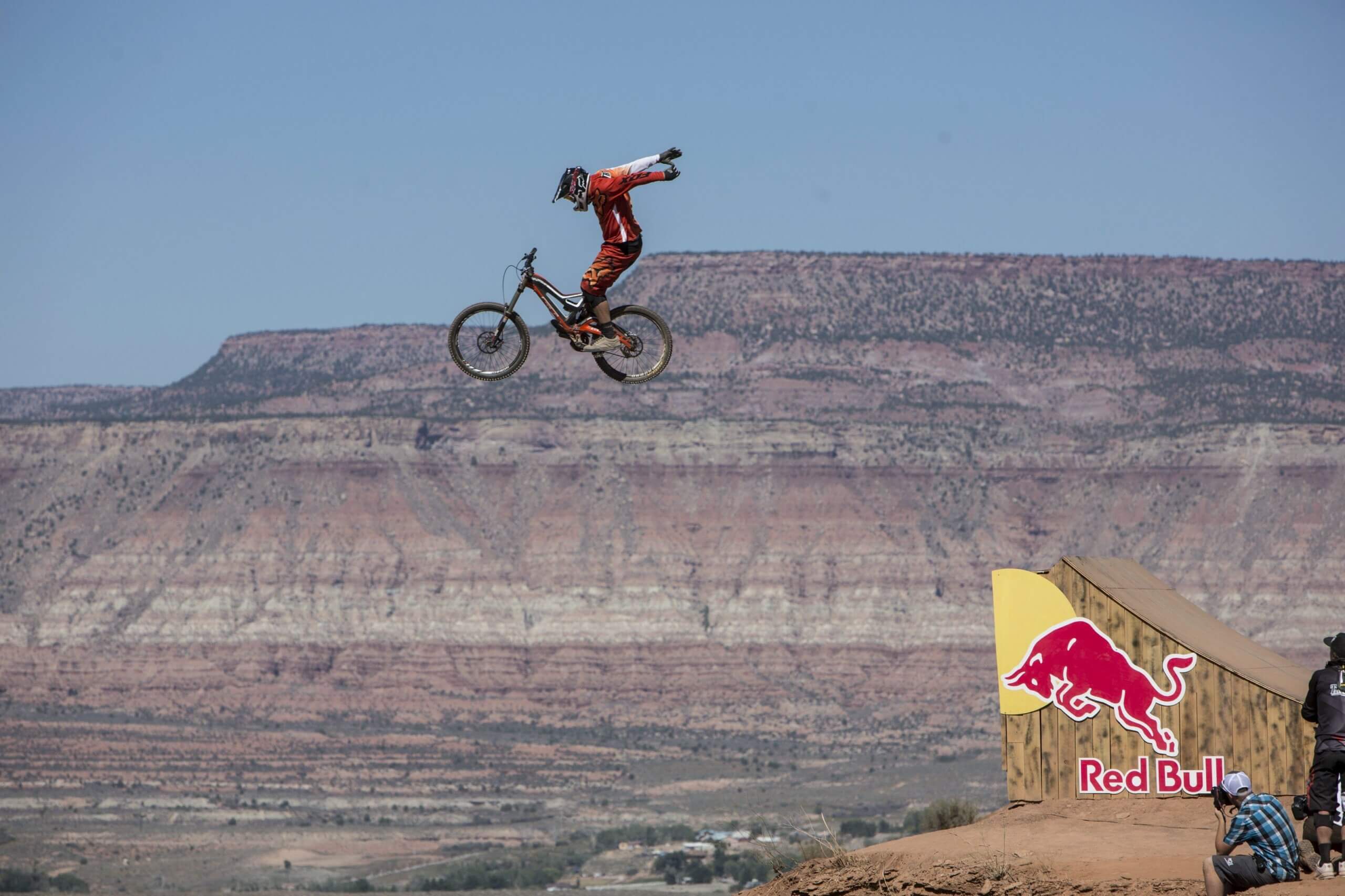 BMX biker jumping off a ramp in the mountains