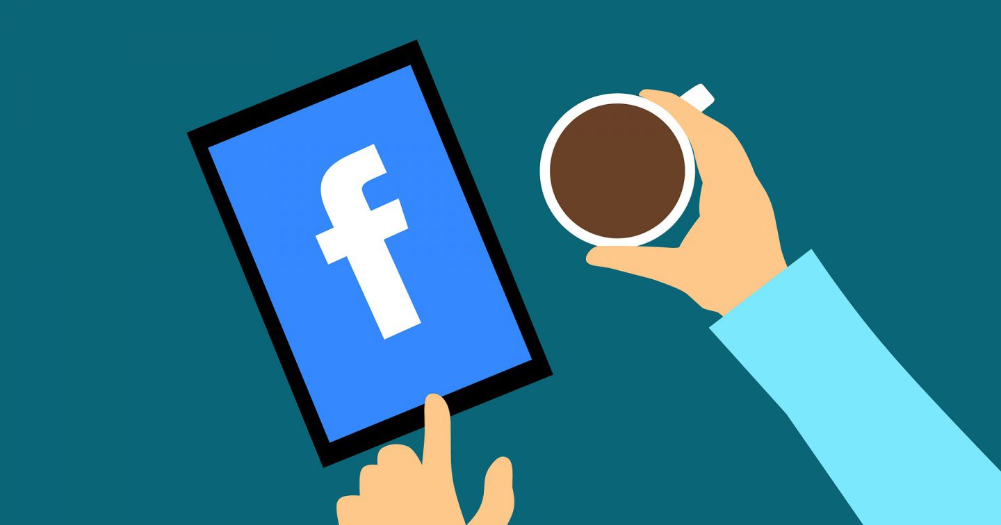 Facebook logo on ipad with hand holding coffee cup