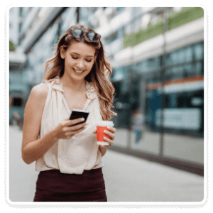 Woman walking down the street on her phone